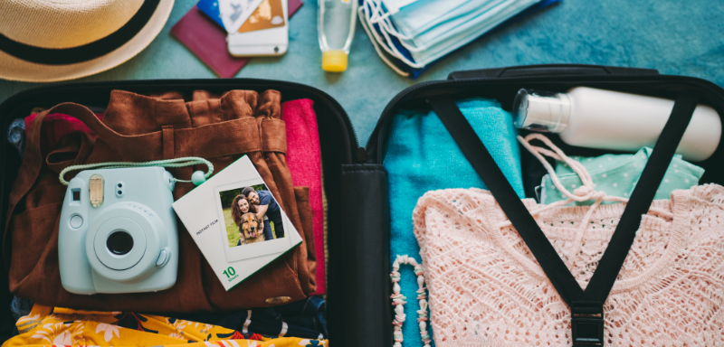 Suitcase with travel items.